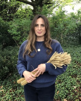 Photo of Artist, Estella Castle, holding dried straw to be prepared for making corn dollies 